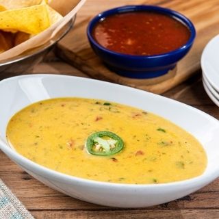 Border Queso: Our Signature Queso mixed with green chile sauce for an extra kick.